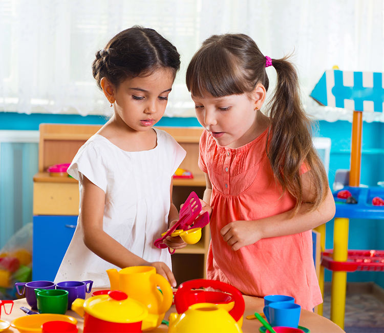 Two girls at Creative Paths Learning Studio collaborate on a classroom project.