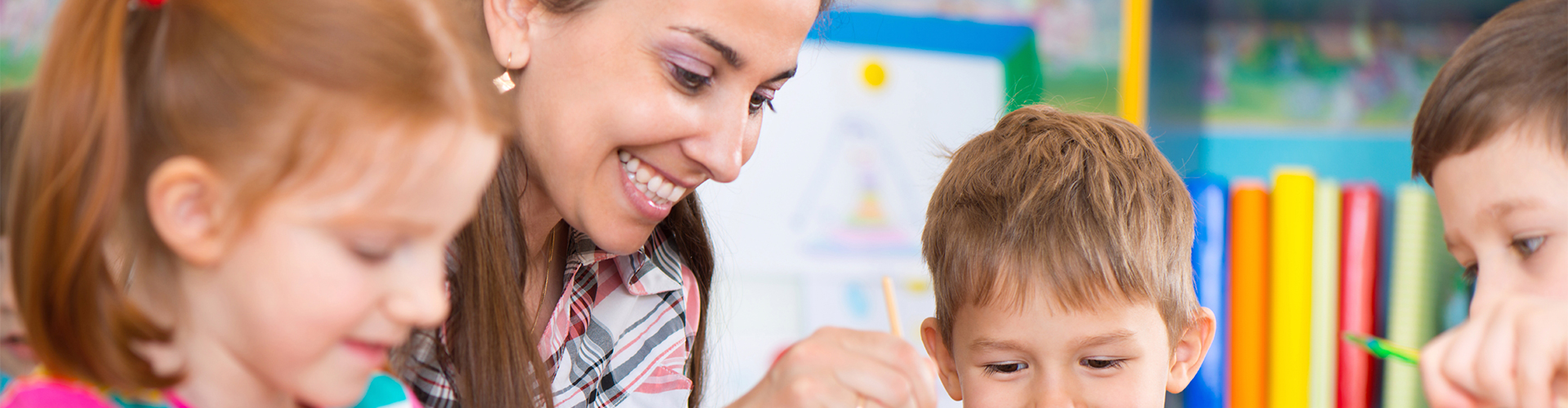 An assistant at Creative Paths Learning Studio guides a children's project.